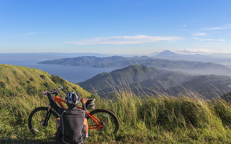 Cycling along grassy trails with mountain and sea views in Hong Kong.