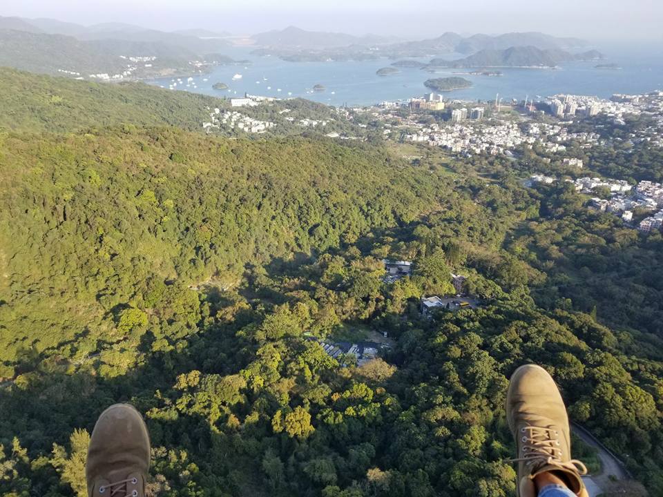 Aerial view from paragliding training flight in Hong Kong with boots visible mid-air